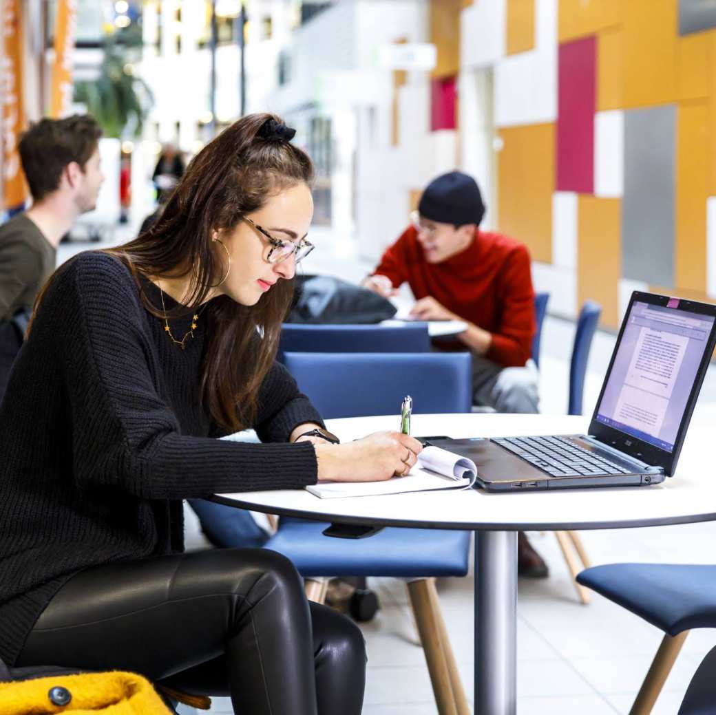 International Student Studying behind a laptop on HAN University Campus in Nijmegen, Netherlands