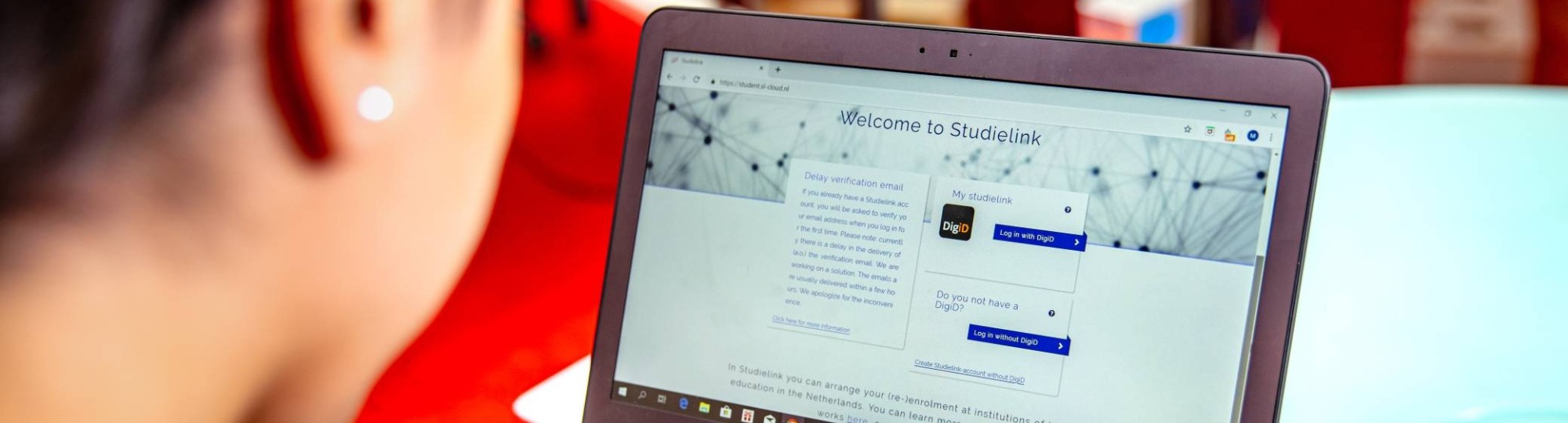 Student achter laptop met Studielink pagina