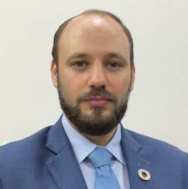 Headshot of a man in blue suit