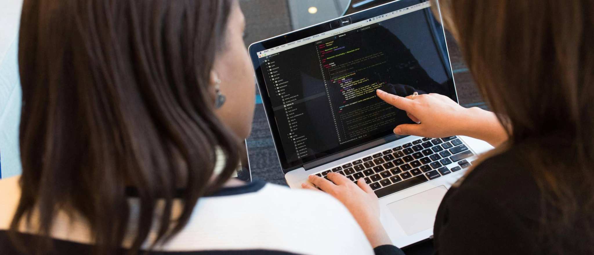 twee personen kijken op een laptop