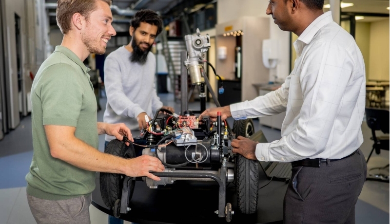 Een docent en twee studenten van de Master Engineering Systems Cyber Physical Systems werken aan het MORE-project, de scootmobiel.