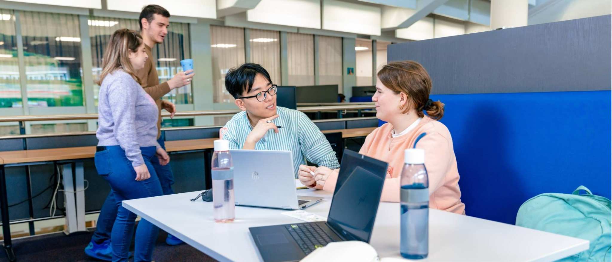 International students Nyugen and Noa studying together in the library on the Arnhem campus of HAN University of Applied Sciences.